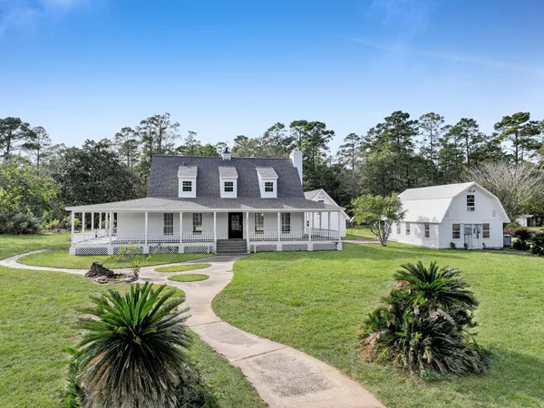 a front view of a house with garden and porch