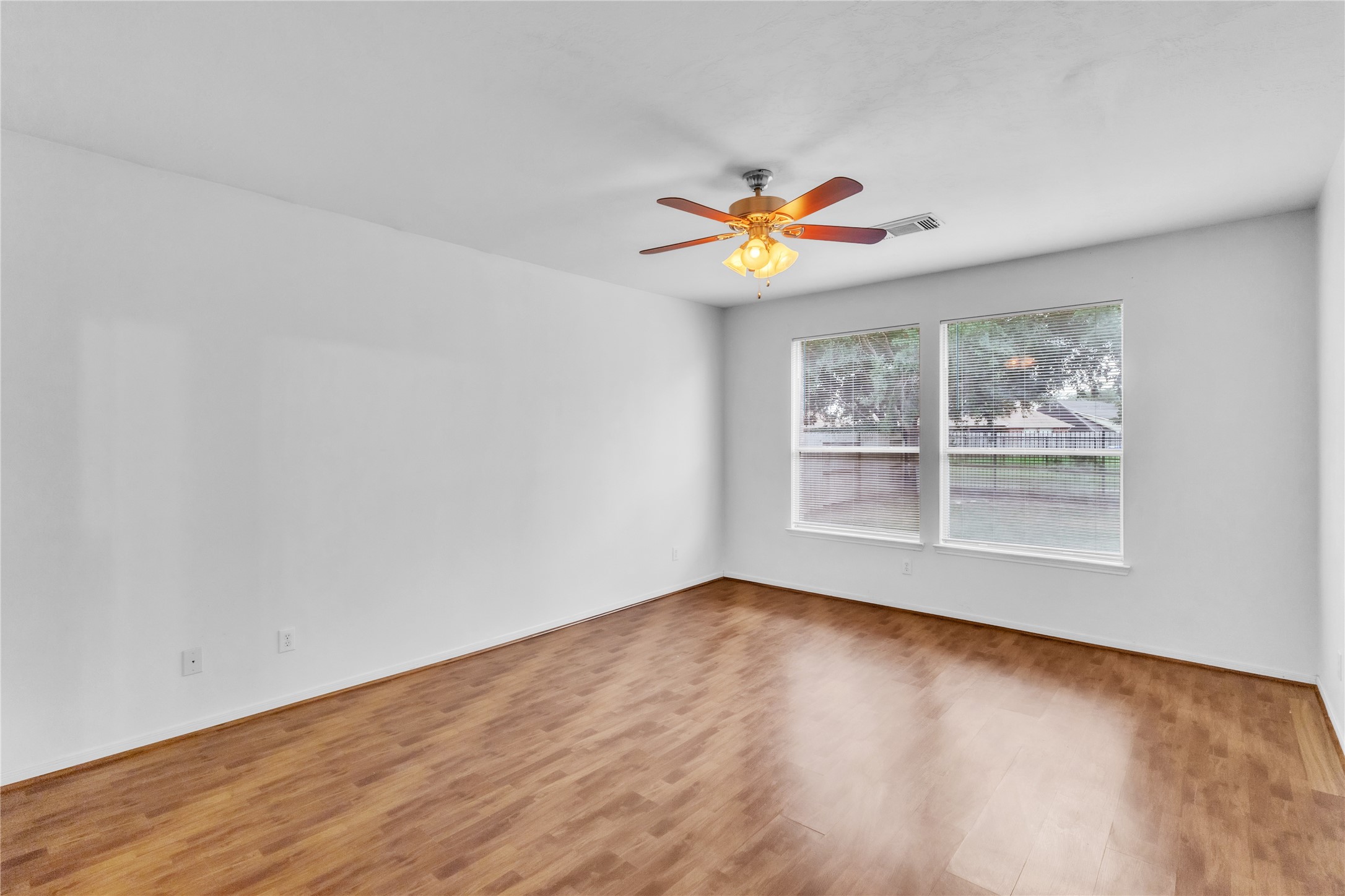 18027 Oak Orchard Lane Cypress, TX 77433 - Photo 17 of 37 an empty room with a window and wooden floor