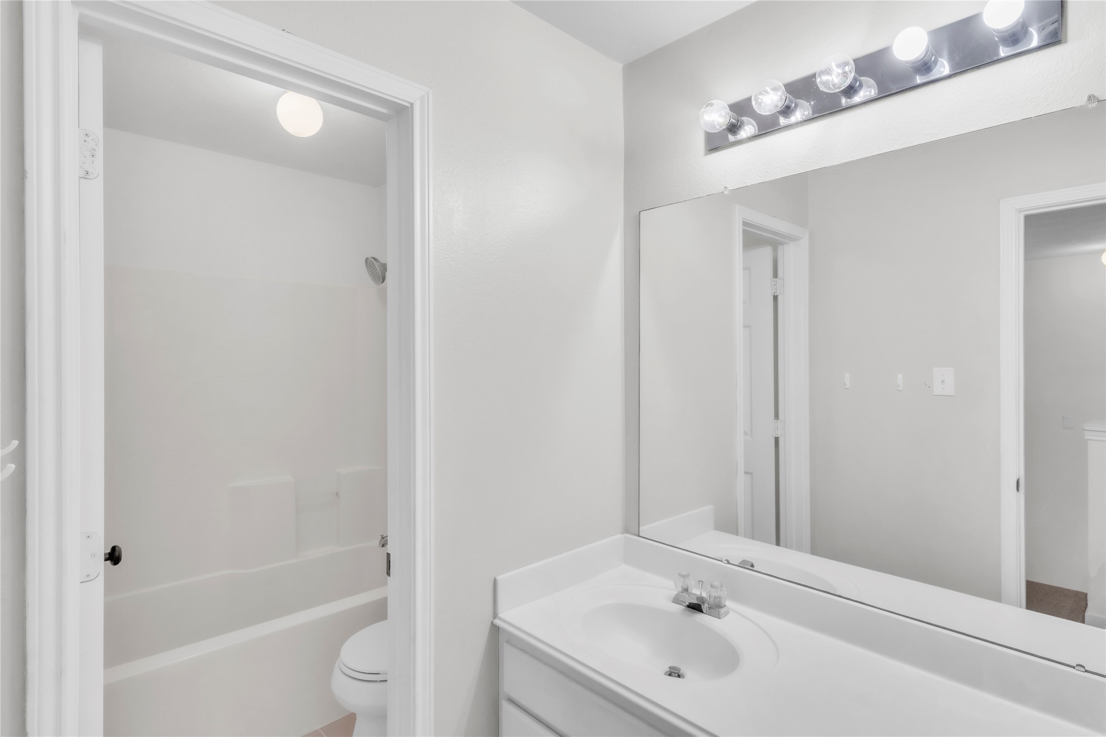 18027 Oak Orchard Lane Cypress, TX 77433 - Photo 29 of 37 a bathroom with a tub shower sink vanity and a toilet