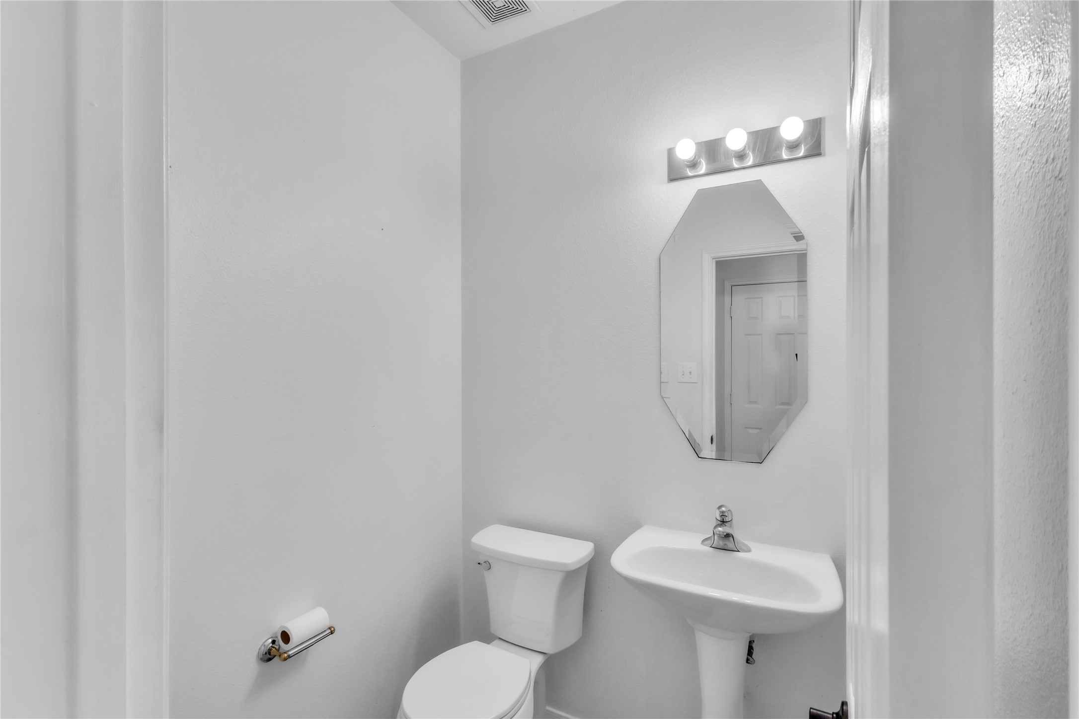 18027 Oak Orchard Lane Cypress, TX 77433 - Photo 8 of 37 a bathroom with a toilet a sink and mirror