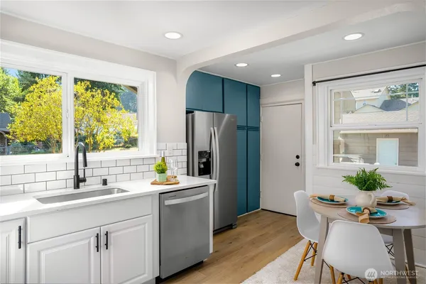 a kitchen with stainless steel appliances a sink a counter space and a window