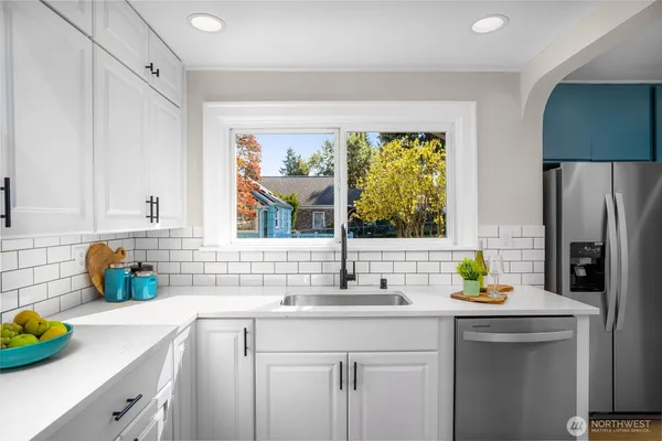 a bedroom with a bed and a lamp on dresser