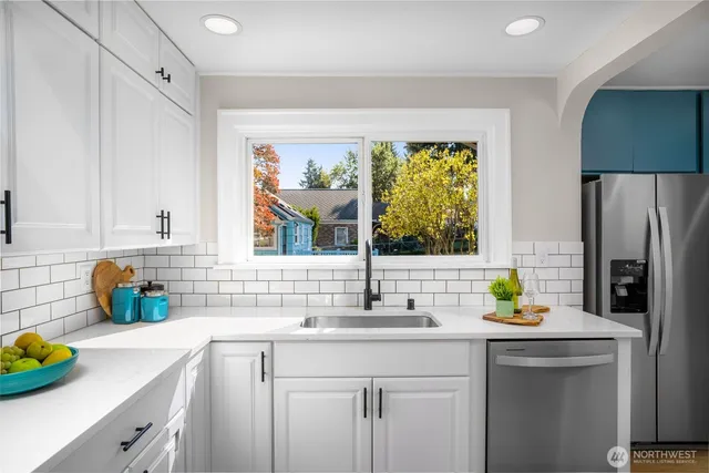 a bedroom with a bed and a lamp on dresser