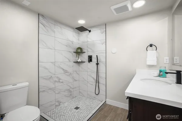 a bathroom with a sink vanity and a mirror