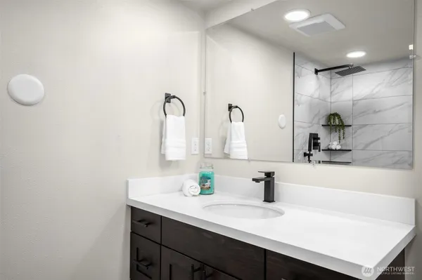 a view of a house with a small yard and wooden floor and fence