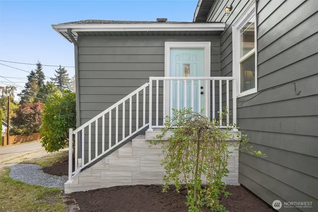 a front view of a house with plants