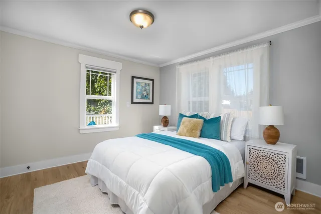 a view of a kitchen area with furniture and wooden floor
