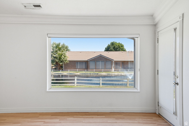 805 South River Road, Unit 70 St. George, UT 84790 - Photo 16 of 38 Interior space featuring a large window, wood-finish flooring, white walls, and crown molding
