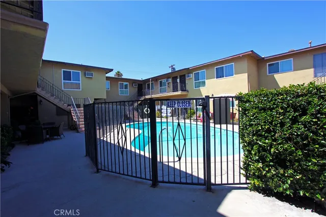 a view of a house with wooden floor fence and a porch