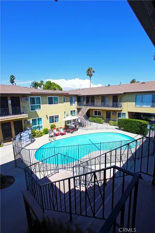 a view of a roof deck with table and chairs a barbeque