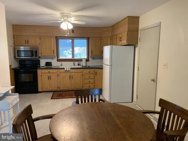 a kitchen with appliances a sink and cabinets