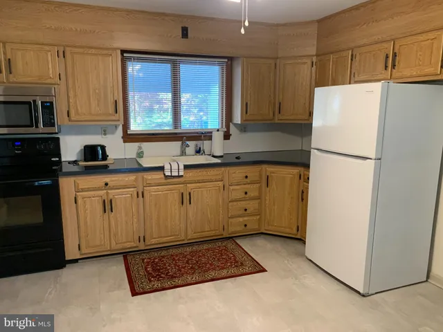 a view of a dining room with furniture and window