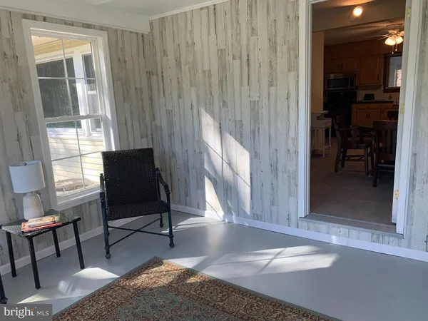 a view of a livingroom with furniture and a window