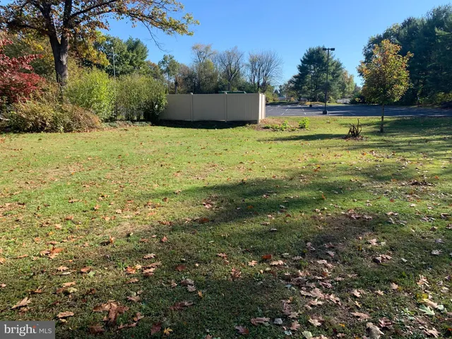 a view of a swimming pool and trees in the background