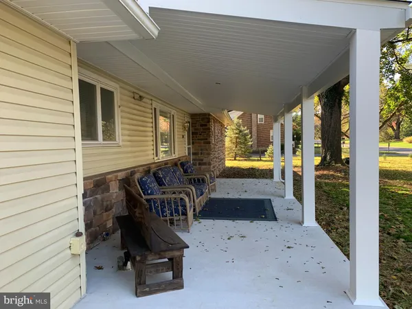 a kitchen with granite countertop a refrigerator a stove a sink a dining table and chairs