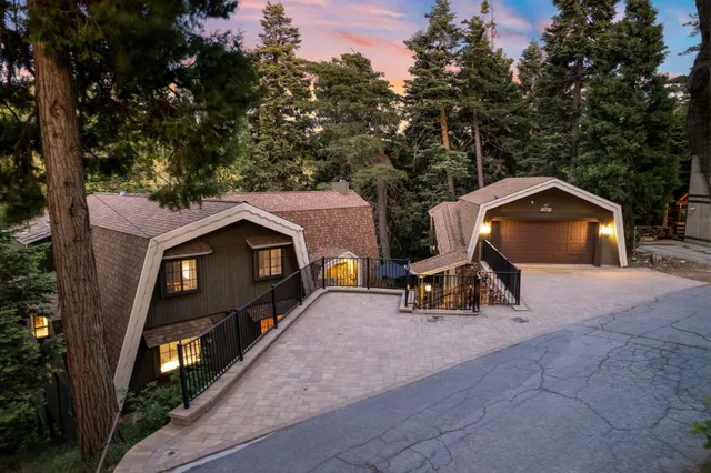 an aerial view of a house with garden space and sitting area