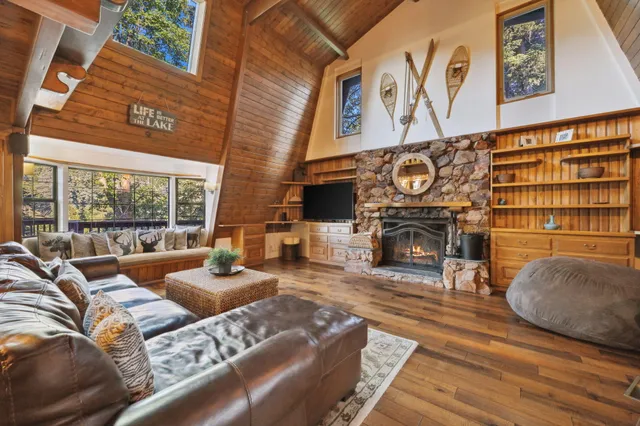 a view of deck with dinning table and chair under an umbrella with wooden floor