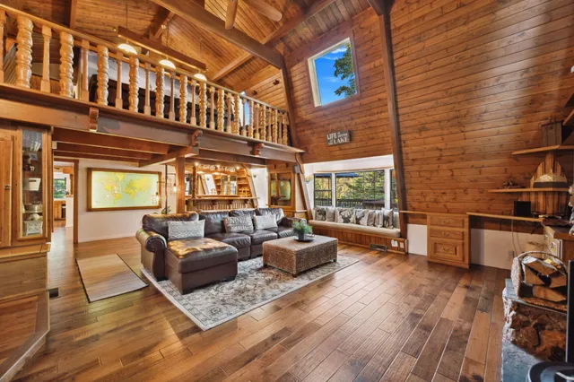 a living room with furniture a table and wooden floor