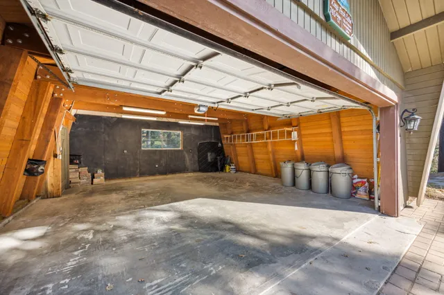 a view of deck with table and chairs under an umbrella with wooden floor