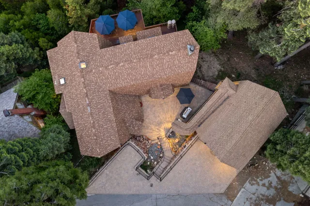 a view of a patio with table and chairs a barbeque with wooden floor and fence