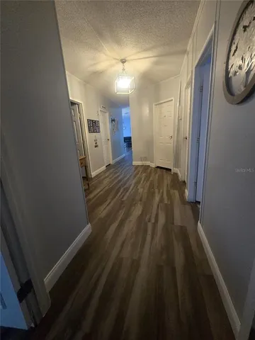 a view of a hallway with wooden floor