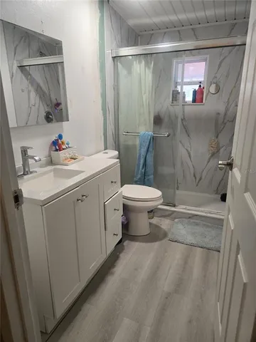 a bathroom with a sink toilet and shower