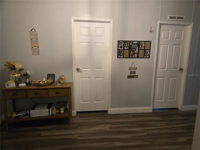 a room with wooden floor and cabinet