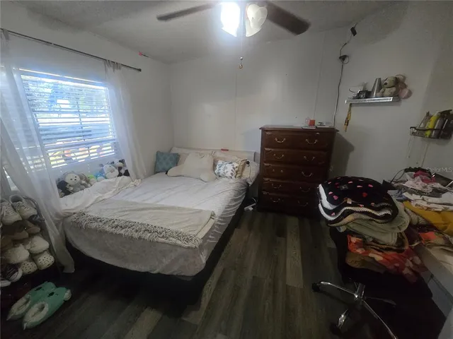 a bed sitting in a bedroom next to a window