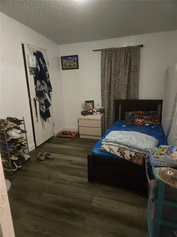 a bedroom with furniture and a closet