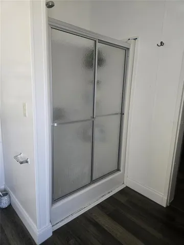 a bathroom with a glass shower door