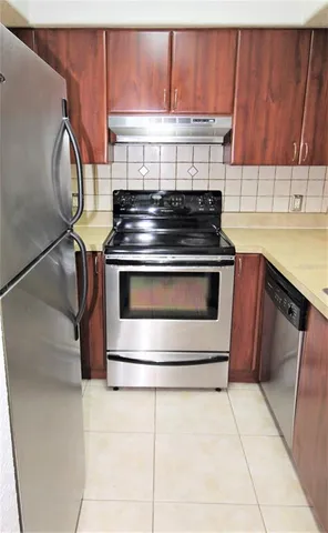 a stove top oven sitting inside of a kitchen