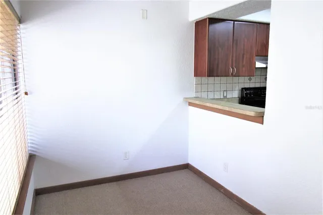 a kitchen with a sink cabinets and a window