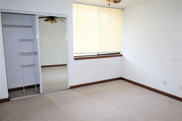 a bathroom with a granite countertop sink toilet a mirror and shower