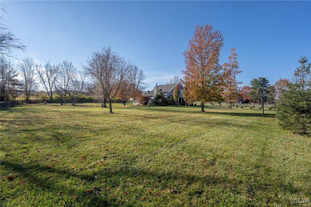 1597 Orchards Road Hellertown, PA 18055 - Photo 18 of 19 a big yard with lots of green space and palm trees