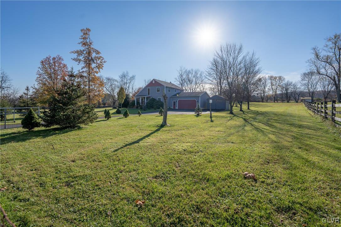 1597 Orchards Road Hellertown, PA 18055 - Photo 3 of 19 a view of a swimming pool with a yard and palm trees