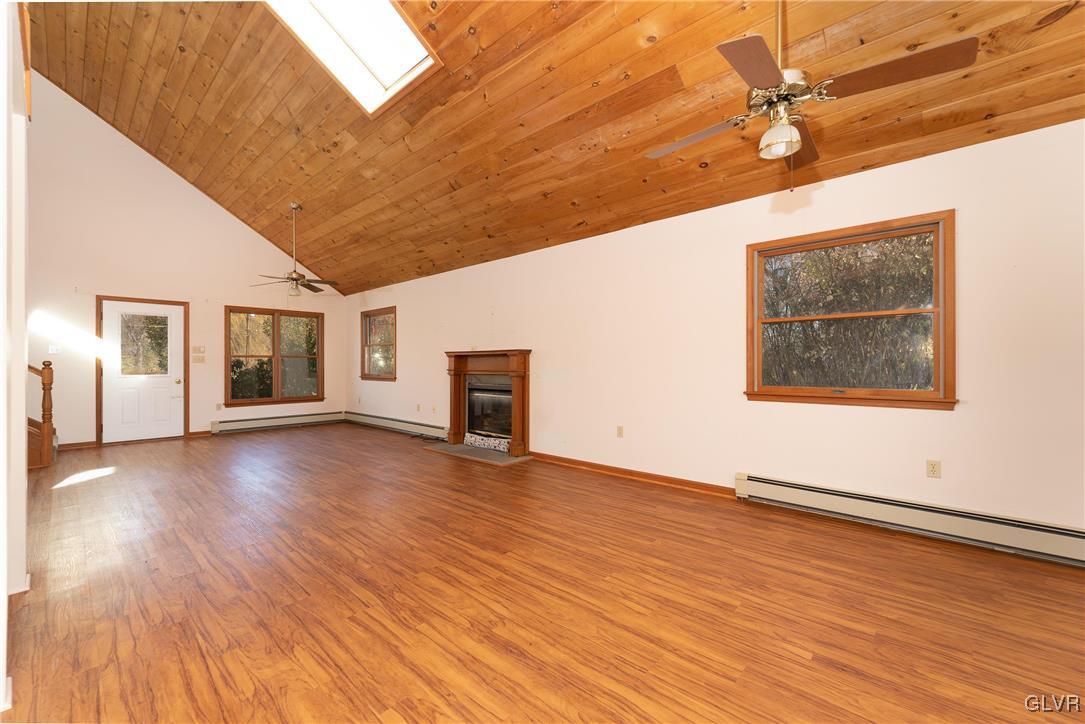 1597 Orchards Road Hellertown, PA 18055 - Photo 5 of 19 a view of an empty room with wooden floor and a window