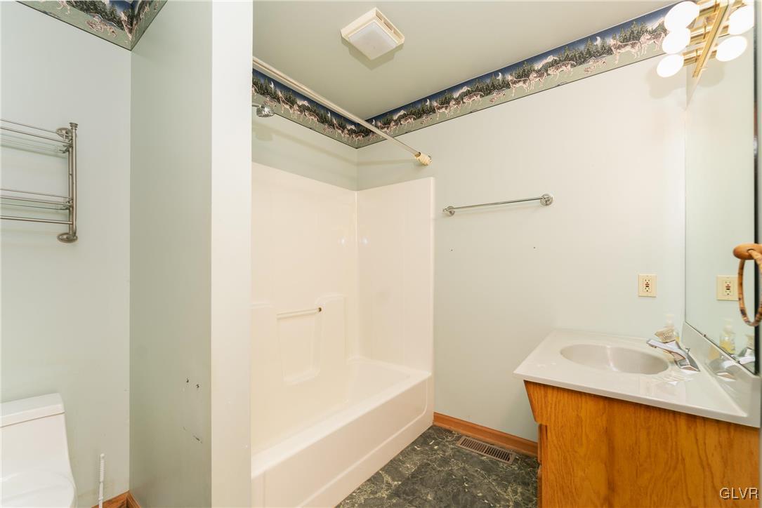 1597 Orchards Road Hellertown, PA 18055 - Photo 10 of 19 a bathroom with a granite countertop sink mirror vanity and shower