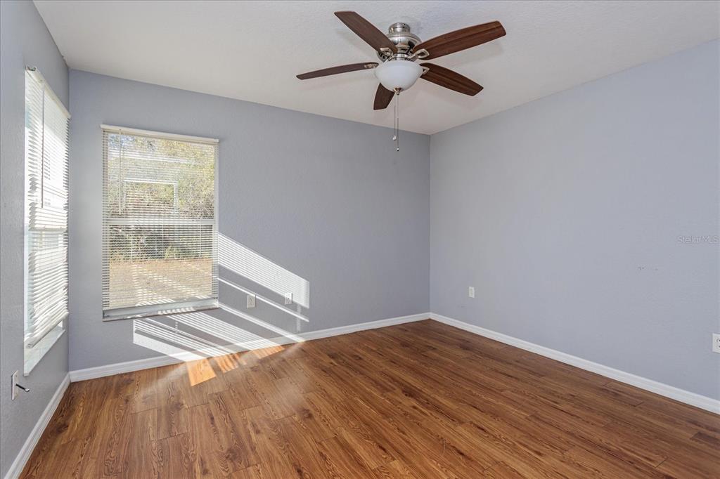 119 Spruce Road Ocala, FL 34472 - Photo 16 of 23 an empty room with wooden floor and windows