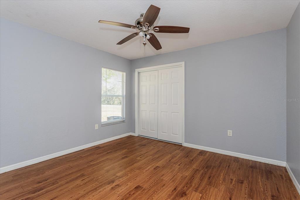 119 Spruce Road Ocala, FL 34472 - Photo 17 of 23 a view of room with a ceiling fan and hardwood floor