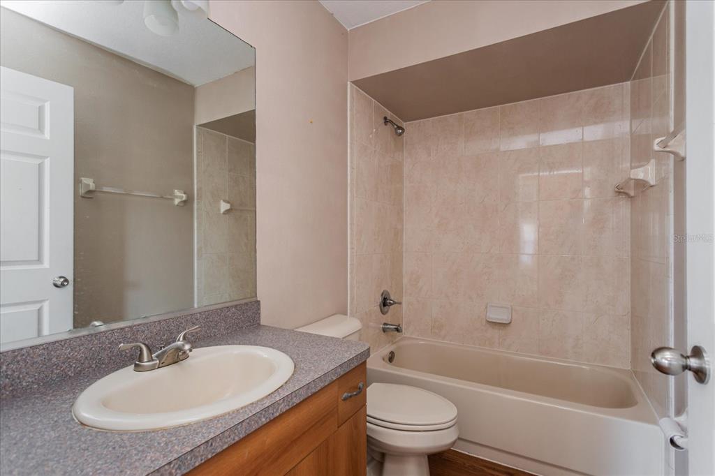 119 Spruce Road Ocala, FL 34472 - Photo 18 of 23 a bathroom with a granite countertop sink toilet and shower