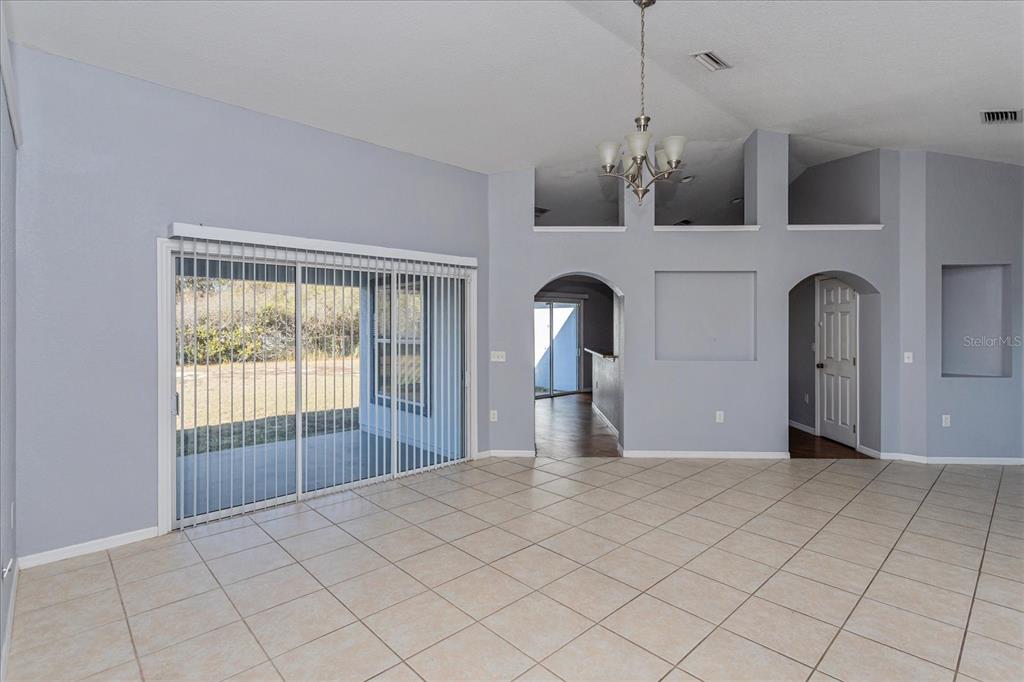 119 Spruce Road Ocala, FL 34472 - Photo 7 of 23 a view of empty room with window and chandelier