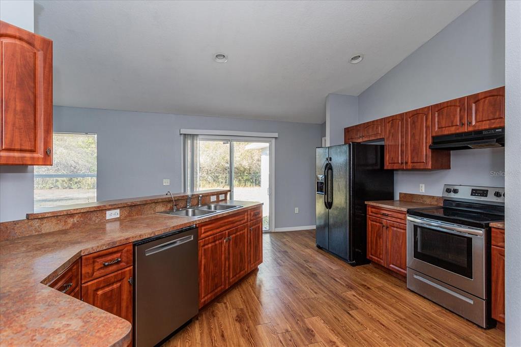 119 Spruce Road Ocala, FL 34472 - Photo 10 of 23 a kitchen with stainless steel appliances granite countertop a stove a sink and a refrigerator