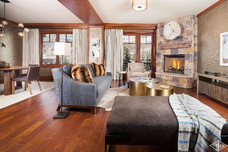 a large living room with fireplace furniture and a large window