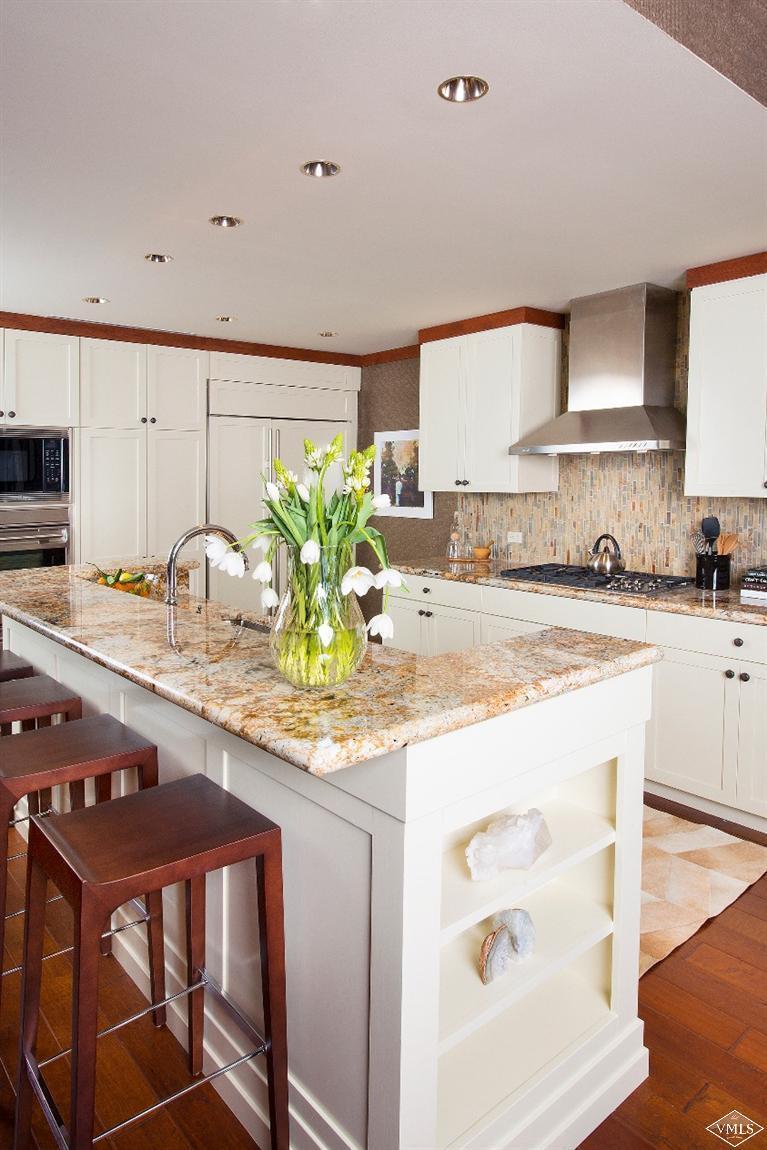 1 Vail Road, Unit 7203 Vail, CO 81657 - Photo 6 of 16 a kitchen with stainless steel appliances granite countertop a sink and cabinets