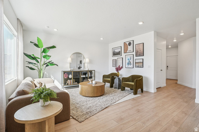 2097 North Ostler Peak Road, Unit 115 Heber City, UT 84032 - Photo 24 of 33 Open-concept living area featuring light wood-finish flooring, recessed lighting, expansive windows, and a neutral color palette