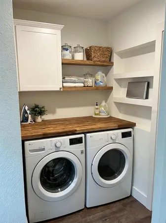 a utility room with sink dryer and washer