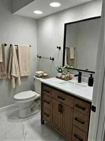 a bathroom with a sink toilet and mirror