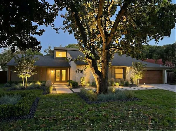 a front view of a house with a garden