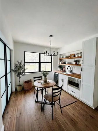 a view of a dining room with furniture window and wooden floor