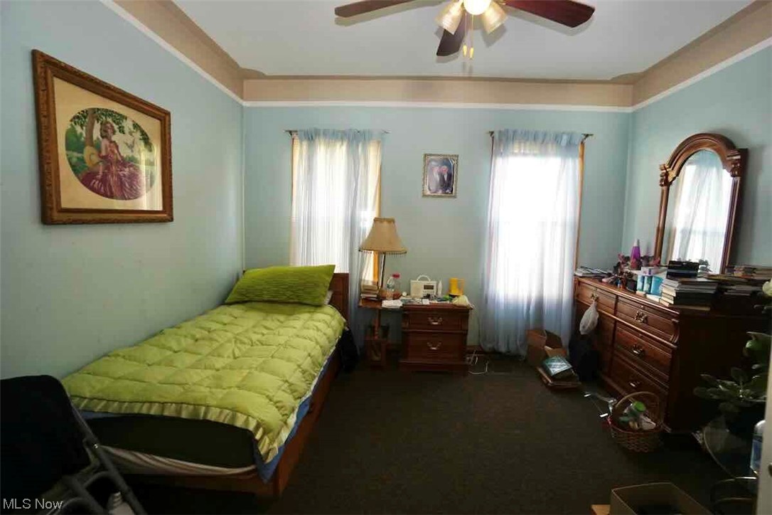 3756 Bosworth Road Cleveland, OH 44111 - Photo 6 of 23 Bedroom with ceiling fan and dark colored carpet
